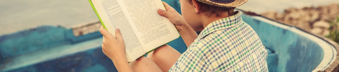Reading boy in old boat